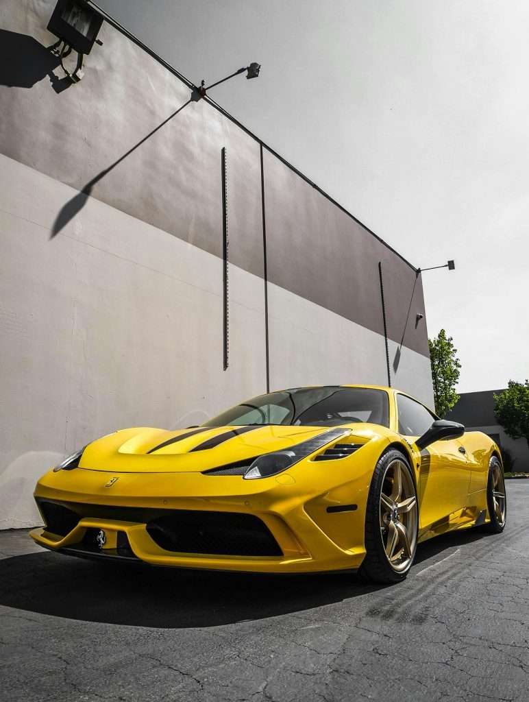 Yellow Sports Car Parked Near A Wall