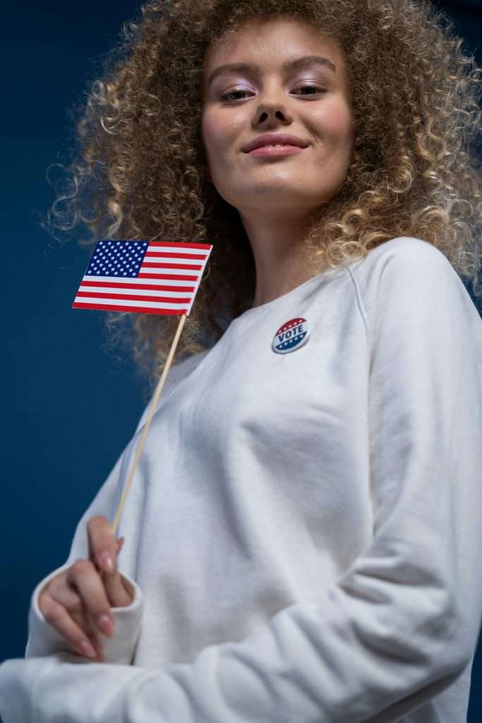 Smiling Woman Holding an American Flag, US 2024 election day