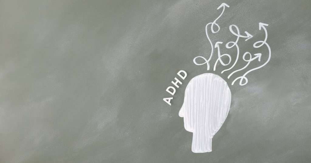 Illustration of ADHD and mental process with head-like outline on chalkboard.